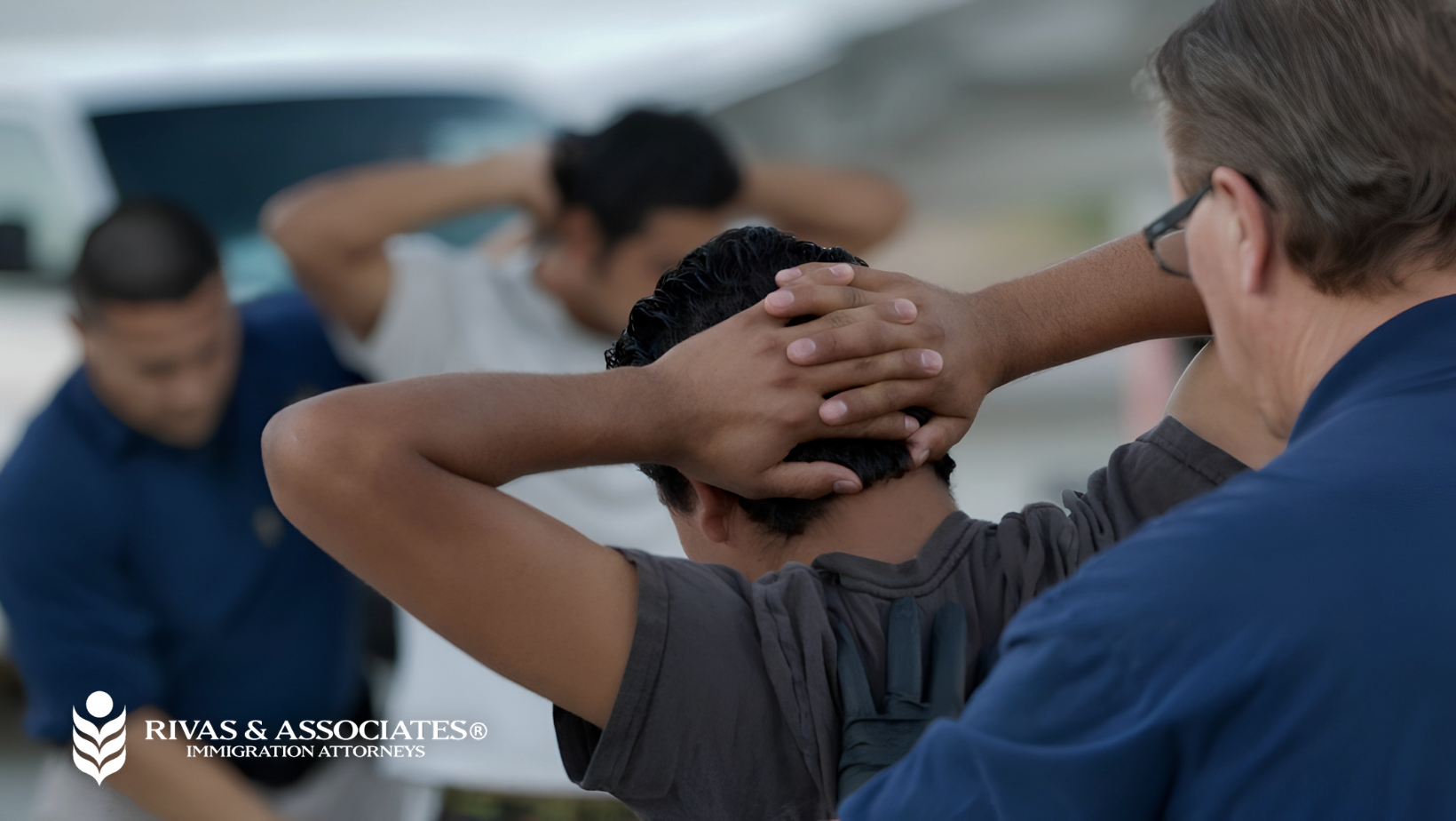 ICE agents detaining men with hands behind their heads, Rivas & Associates immigration attorneys