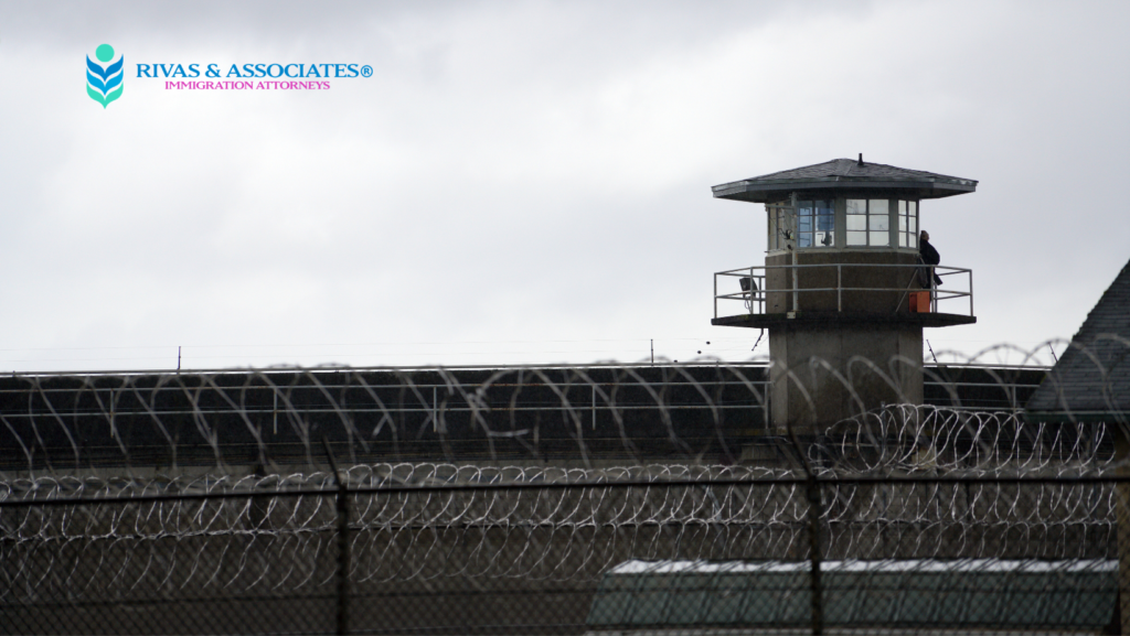 Prison watchtower and razor wire fence at an ICE detention center, Rivas & Associates immigration attorneys