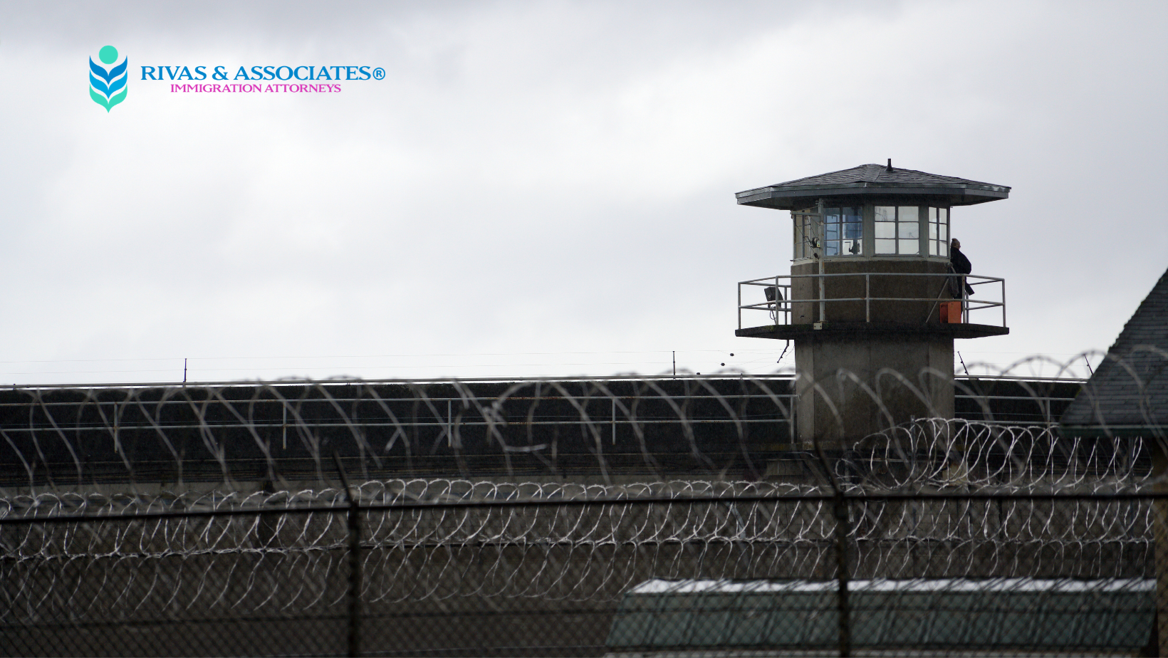 Prison watchtower and razor wire fence at an ICE detention center, Rivas & Associates immigration attorneys